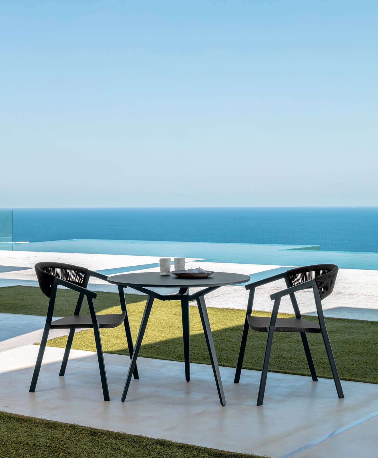 Charcoal grey and black are the dark colours of this beautiful outdoor armchair perfect for a dining table. Luxurious furniture with home delivery.